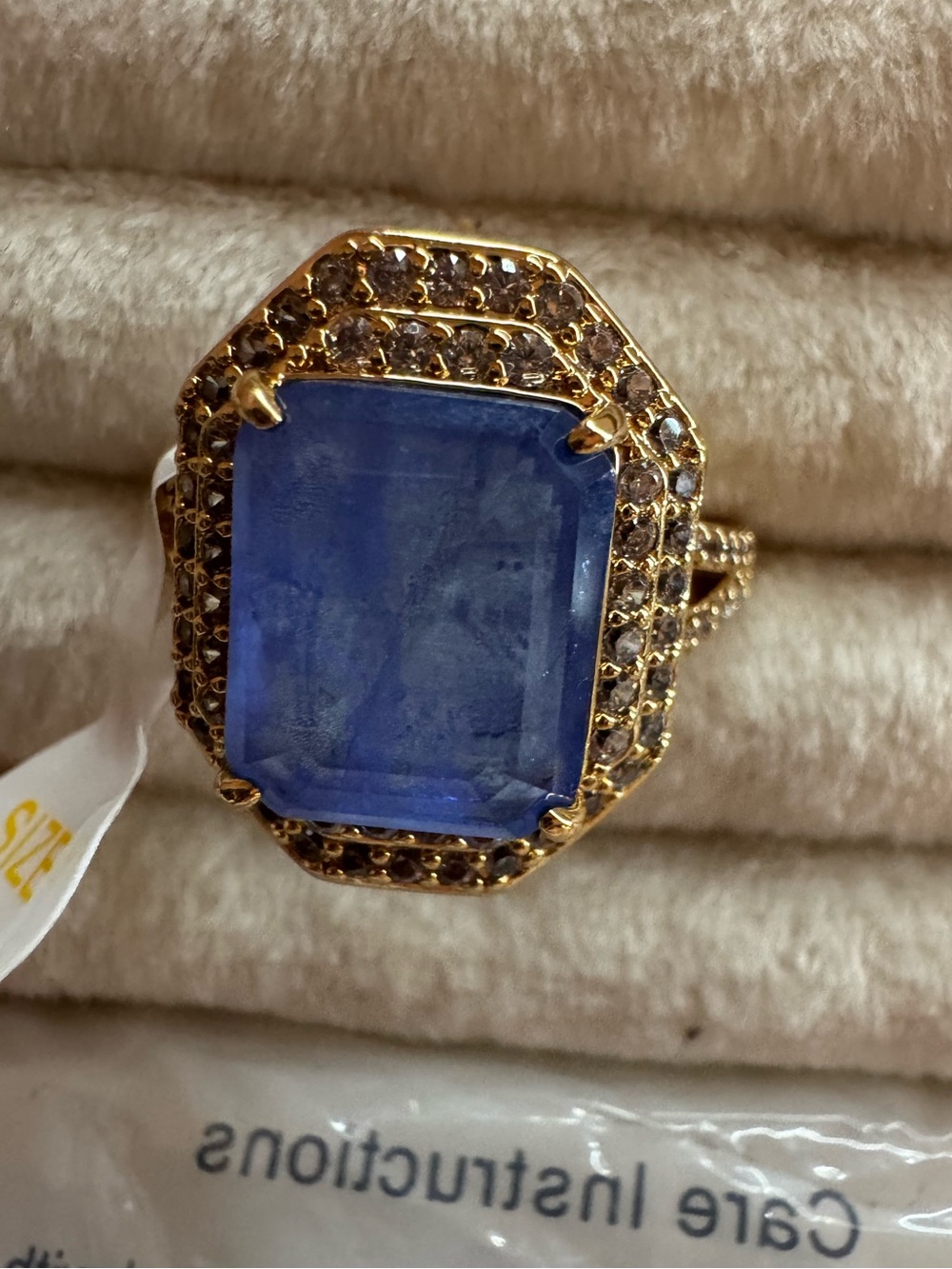 Heartbreaker’s Halo Gold Cocktail Ring with Deep Blue Center Stone